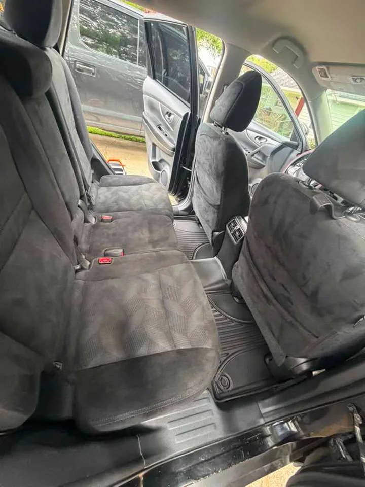 The same back seat after detailing — seats clean, floor mats spotless